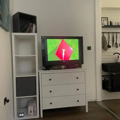 a tv sitting on top of a dresser at The Šljivka in Belgrade