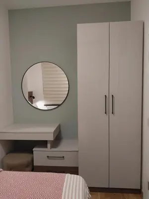 a bedroom with a mirror and a white cabinet at Lider Lux Apartman in Arandjelovac