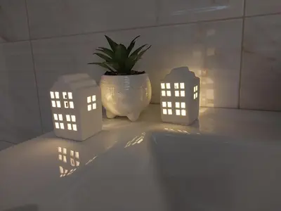 a plant in a vase sitting on a table with lights at Lider Lux Apartman in Arandjelovac