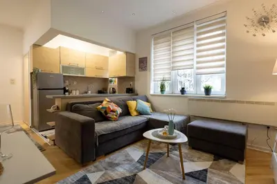 a living room with a couch and a kitchen at Train 23 in Belgrade