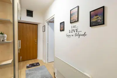 a hallway with a door with a sign that reads like love happy apartment at Train 23 in Belgrade