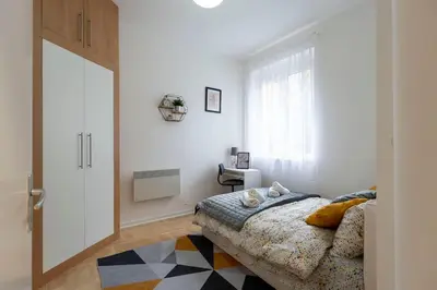 a bedroom with a bed and a window at Train 23 in Belgrade