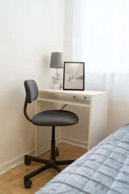 a desk with a chair next to a bed at Train 23 in Belgrade