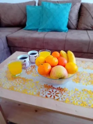 a bowl of fruit sitting on a coffee table at Ruma Deluxe 90m2 in Ruma
