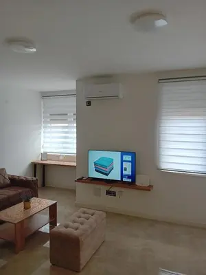 a living room with a couch and a flat screen tv at Ruma Deluxe 90m2 in Ruma