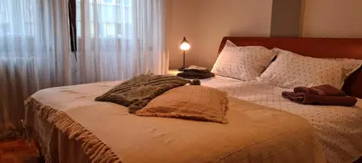 a bedroom with a large bed with a lamp on it at Grey apartment Novi Beograd in Belgrade