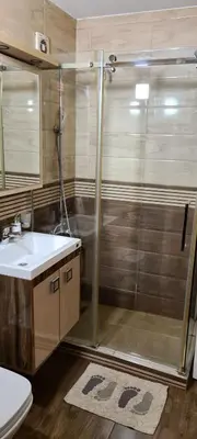 a bathroom with a shower and a sink and a toilet at Grey apartment Novi Beograd in Belgrade