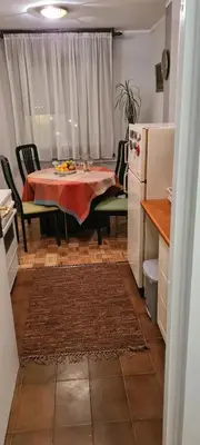 a kitchen with a table and chairs and a refrigerator at Grey apartment Novi Beograd in Belgrade