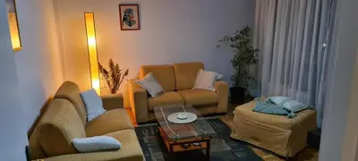 a living room with two couches and a table at Grey apartment Novi Beograd in Belgrade