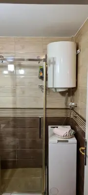 a small kitchen with a refrigerator and a sink at Grey apartment Novi Beograd in Belgrade