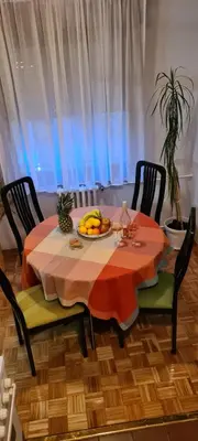 a dining room table with a bowl of fruit on it at Grey apartment Novi Beograd in Belgrade
