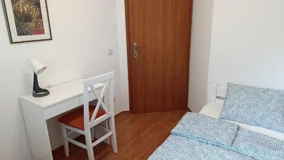 a bedroom with a desk and a bed and a chair at Apartman Anja in Velika Granice