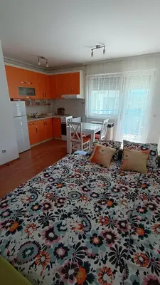 a living room with a large bed with a flower pattern at Apartman Anja in Velika Granice