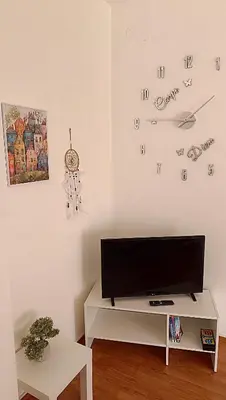 a living room with a flat screen tv on a wall at Apartman Anja in Velika Granice