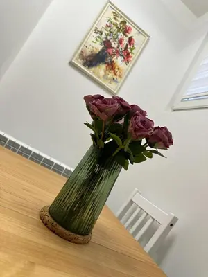 a vase with flowers in it on a table at NBG113 apartment in Belgrade