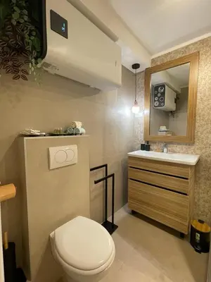 a bathroom with a white toilet and a sink at NBG113 apartment in Belgrade