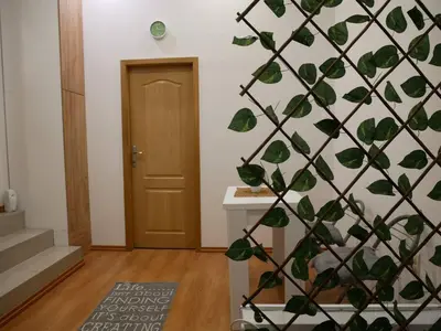 a room with a wall covered in green leaves at Cozy place in Belgrade