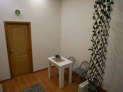 a room with a table and two chairs and a door at Cozy place in Belgrade