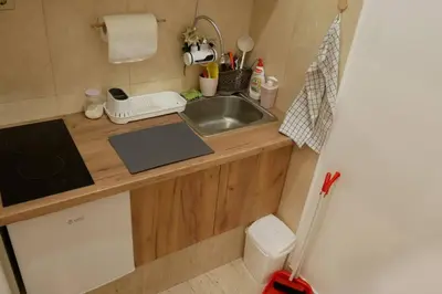 a small kitchen with a sink and a counter at Cozy place in Belgrade