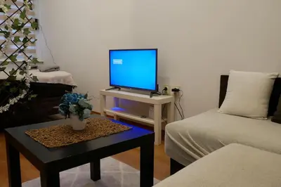 a living room with a computer monitor on a table at Cozy place in Belgrade