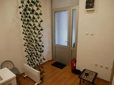 a room with a hallway with a door and a window at Cozy place in Belgrade