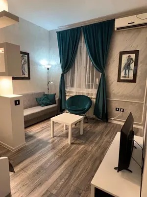 a living room with a couch and a table at M&L downtown apartment in Sajmište