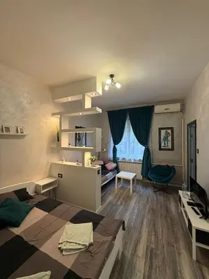 a bedroom with a bed and a desk in it at M&L downtown apartment in Sajmište