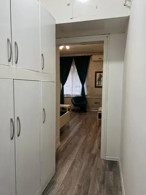 a living room with white cabinets and a hallway at M&L downtown apartment in Sajmište