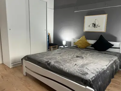 a bedroom with a bed with black and yellow pillows at Old town Belgrade apartment in Belgrade