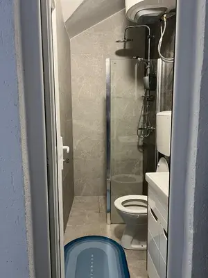 a small bathroom with a shower and a toilet at Old town Belgrade apartment in Belgrade