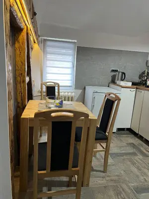 a kitchen with a wooden table and chairs at Old town Belgrade apartment in Belgrade