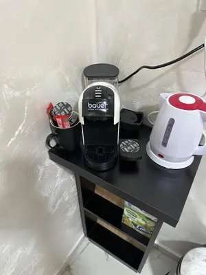 a black table with a coffee maker on it at Stan na dan Jovanovic in Kneževac