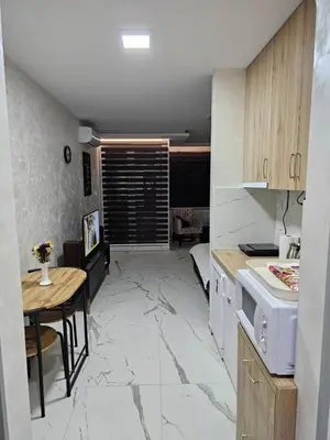 a kitchen with a small table and a kitchen with a stove at Stan na dan Jovanovic in Kneževac