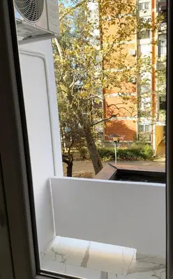 a window with a white bench looking out of it at Stan na dan Jovanovic in Kneževac