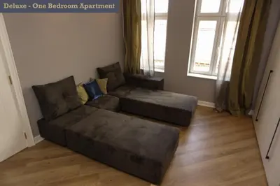 a living room with a couch and a chair at Moment Boutique Apartments in Belgrade
