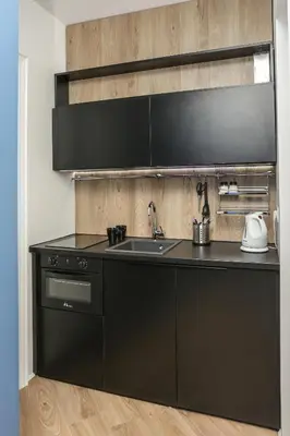 a kitchen with a black counter top and a sink at Moment Boutique Apartments in Belgrade