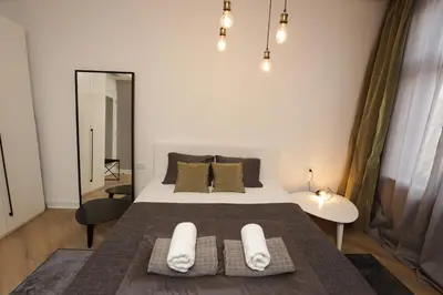 a bedroom with a bed with two towels on it at Moment Boutique Apartments in Belgrade