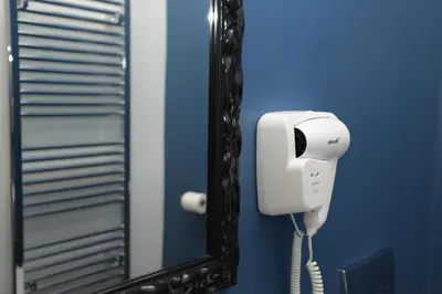 a mirror with a phone in a bathroom at Moment Boutique Apartments in Belgrade
