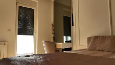 a bedroom with a bed and a desk and a window at New&Luxurious, Central&Comfortable in Belgrade