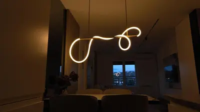 a light fixture hanging from the ceiling in a dining room at New&Luxurious, Central&Comfortable in Belgrade