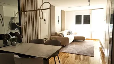 a living room with a couch and a table at New&Luxurious, Central&Comfortable in Belgrade