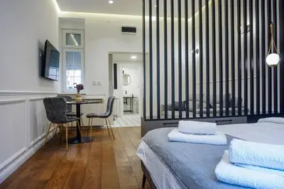 a bedroom with a bed and a table and chairs at City life in Belgrade