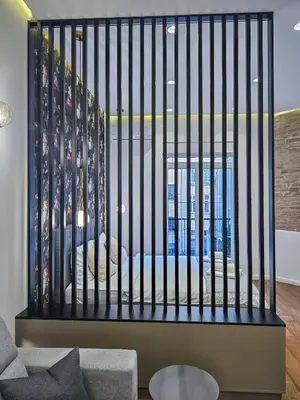 a black fence in a room with a bed at City life in Belgrade