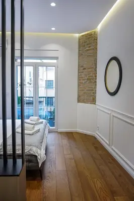 a bedroom with a bed and a mirror on the wall at City life in Belgrade