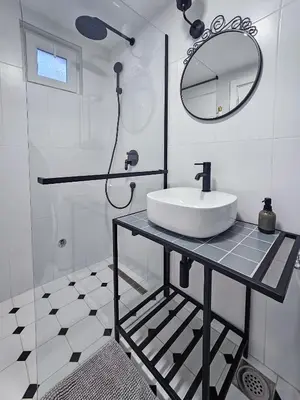 a white bathroom with a sink and a mirror at City life in Belgrade