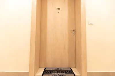 a wooden door with a welcome sign in a room at Galerija Libera in Belgrade