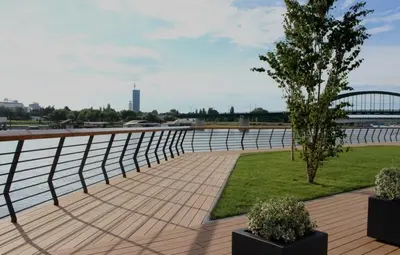 a walkway next to a river with a fence at Galerija Libera in Belgrade