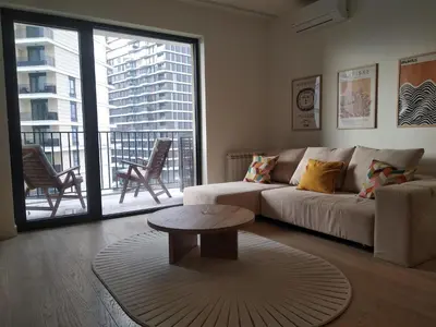 a living room with a couch and a table at BW Premium 5th Symphony in Belgrade
