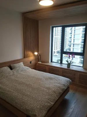 a bedroom with a bed and a large window at BW Premium 5th Symphony in Belgrade