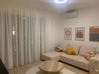 a living room with a couch and a table at BW Premium 5th Symphony in Belgrade